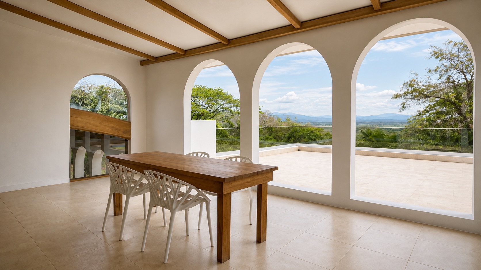 Comedor con arcos abiertos a la terraza y al valle
